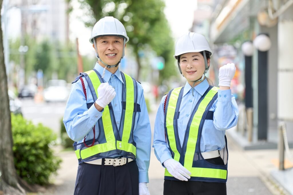 Asian male and female security guards doing fist pumps
